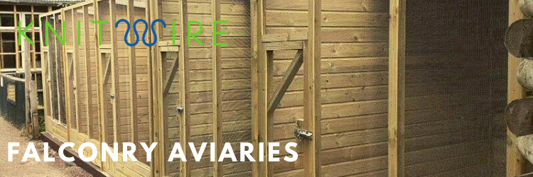 row of falconry aviaries made of wood and clearmesh